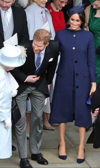 Queen Elizabeth II speaks with the Duke and Duchess of Sussex outside St George’s Chapel in Windsor Castle, following the wedding of Princess Eugenie to Jack Brooksbank on Oct. 12, 2018 in Windsor, England.